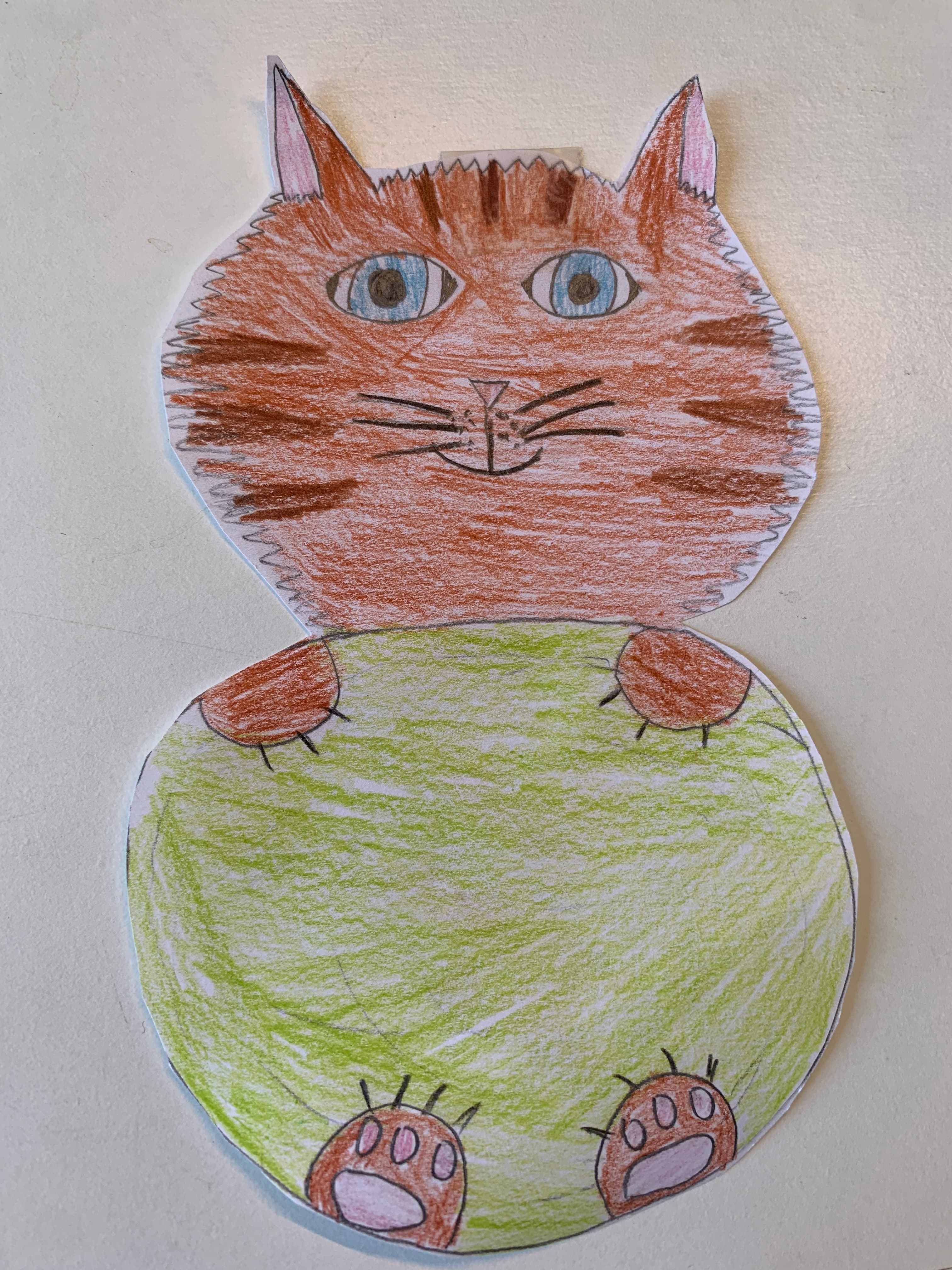 Child's drawing of an orange cat hugging a green ball