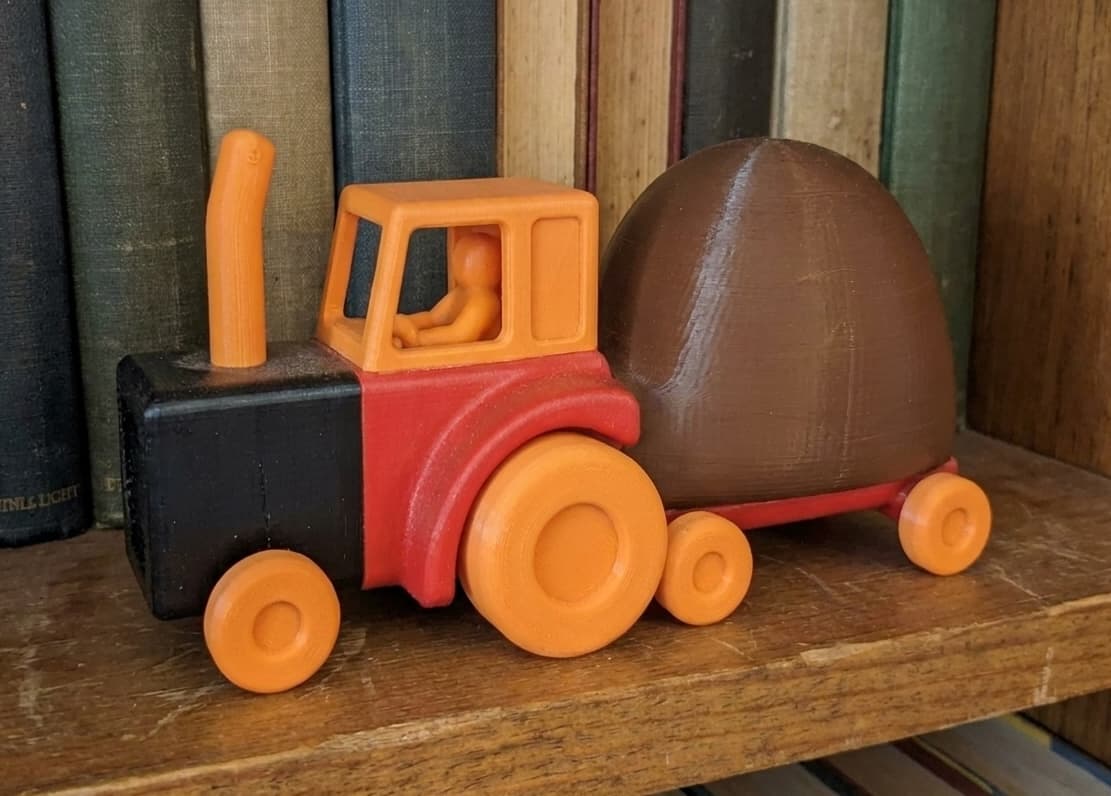 3D printed tractor figurine on a bookshelf